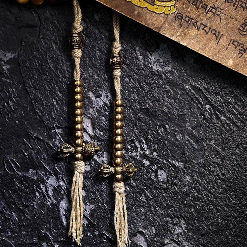 Copper Vajra charm and woven cotton tassel counters detail from Buddhist prayer mala beads