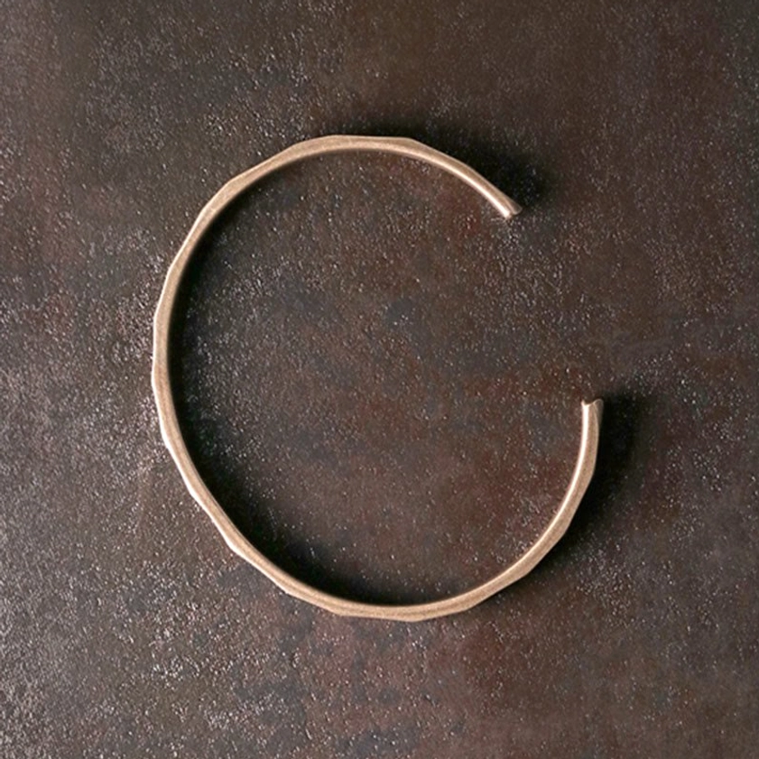 Buddhist copper wealth bracelet overhead top-down view showing round open band simple design with matte copper finish