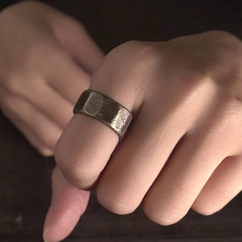 Frosted copper brass wealth rings worn on hand showing natural daily wear and slim bronze band styling