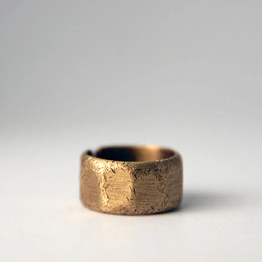 Frosted copper brass wealth ring three-quarter view on minimalist white background showing frosted bronze surface