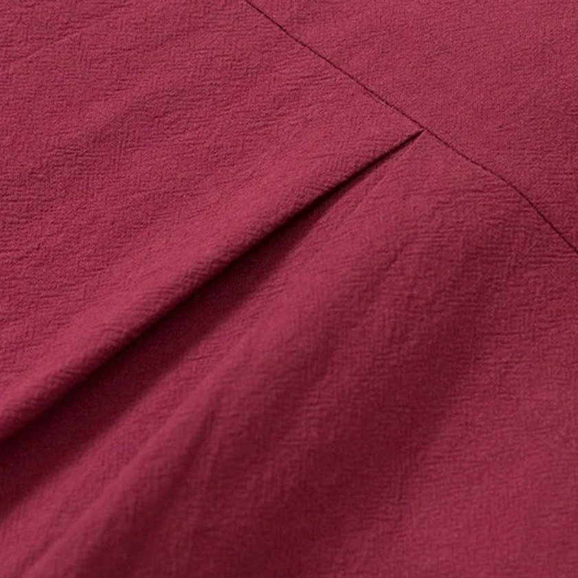Cotton fabric and seam detail of men's Buddhist meditation shirt, burgundy stitched construction