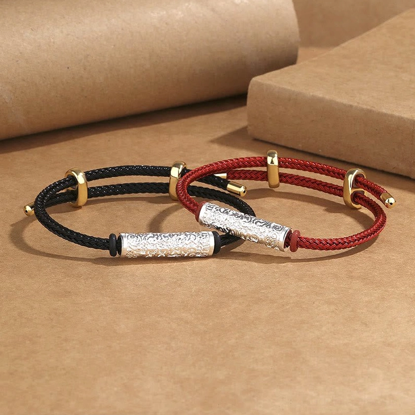 Couple Buddhist braided string bracelets black and red with silver and gold copper hardware on kraft paper