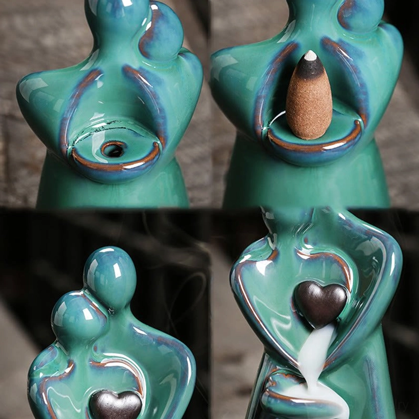Close-up details of handcrafted ceramic incense burner showing incense slot and heart decoration