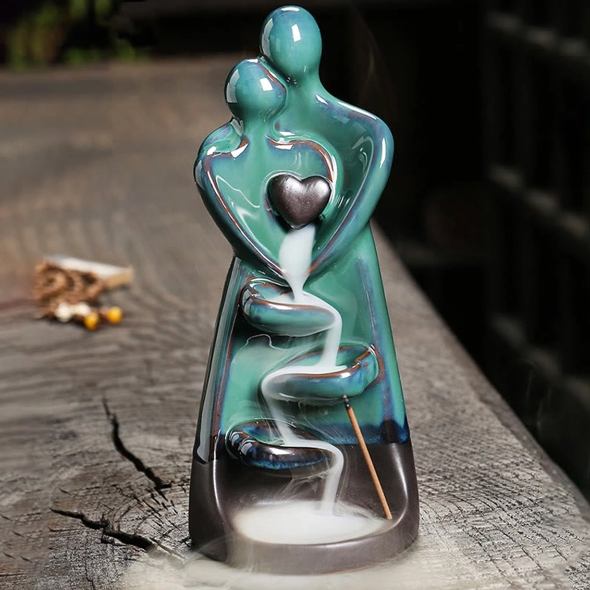 Hand-painted ceramic couple embrace burner with cascading incense smoke and spiral flow channels