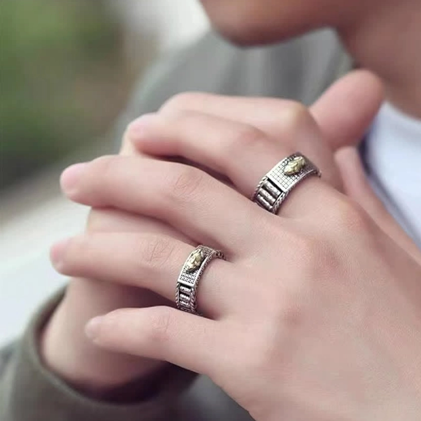 Couple wearing matching Pixiu wealth rings - casual hand-wear close-up showing open adjustable band and embossed prosperity symbol design for spiritual practice