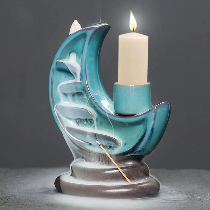 Handcrafted ceramic crescent moon backflow incense burner with flowing smoke and lit candle, meditation decor