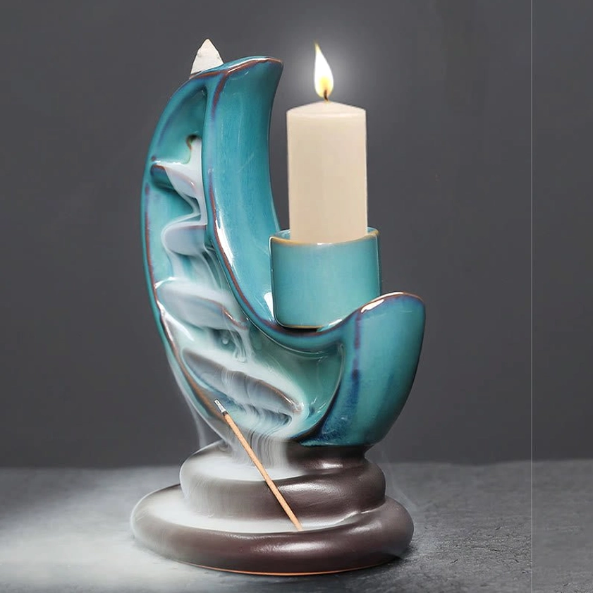 Front right angle of handcrafted ceramic crescent moon burner with lit pillar candle and incense smoke effect