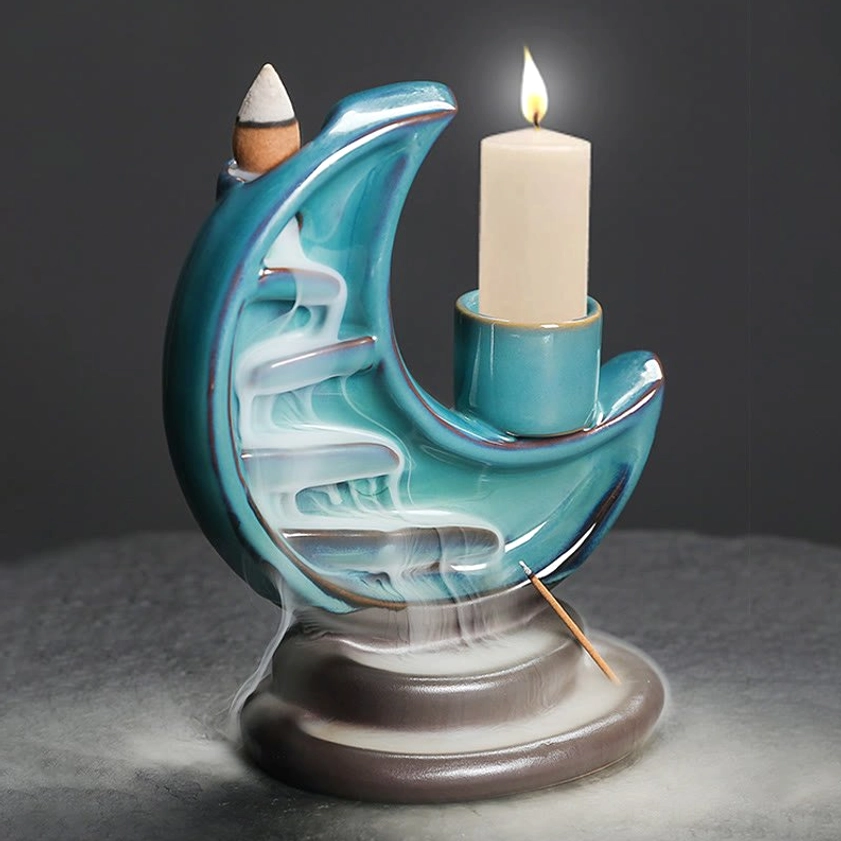 Crescent moon backflow incense burner with lit candle and flowing incense smoke, meditation ambiance
