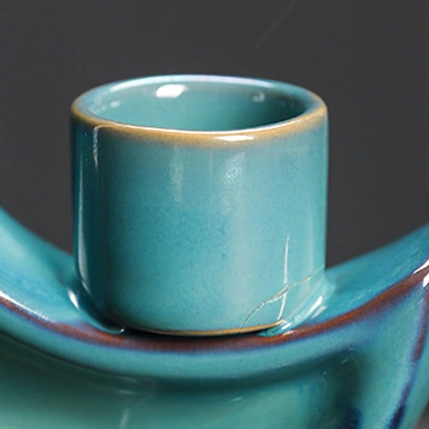 Teal ceramic crescent moon backflow incense burner with dark brown base, complete product view