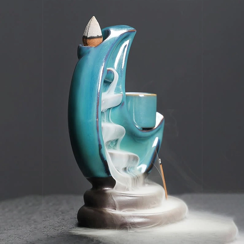 Rear angle of ceramic crescent moon backflow incense holder with visible smoke flow design, handmade quality