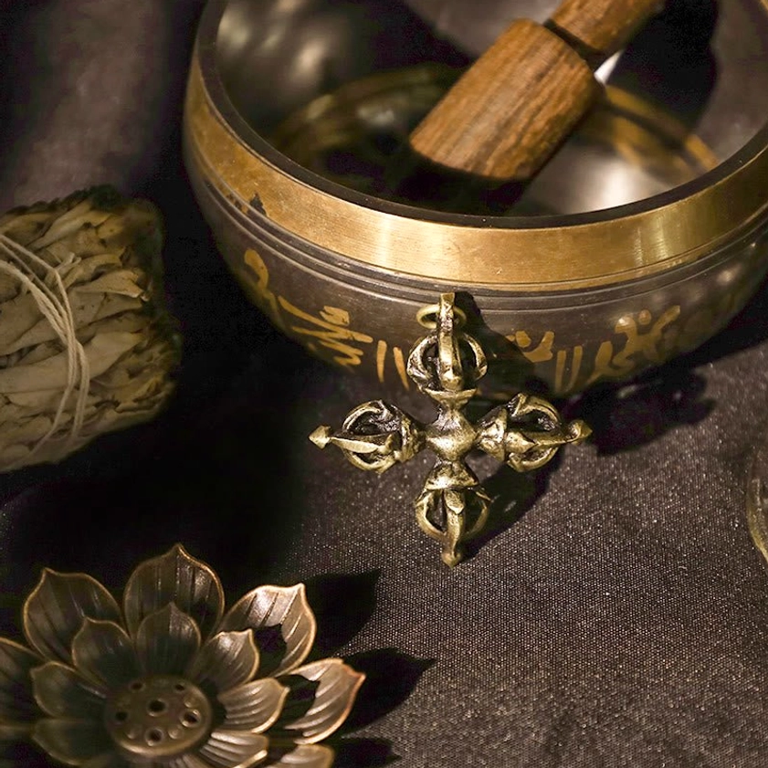 Cross vajra dorje with aged brass mantra-etched singing bowl in complete spiritual ritual setting display