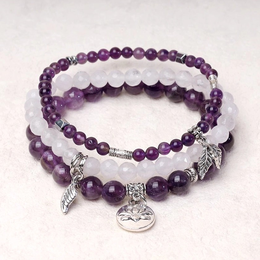 Set of 3 healing crystal bracelets with purple and white quartz beads, silver leaf charm and lotus pendant - flat lay desktop display