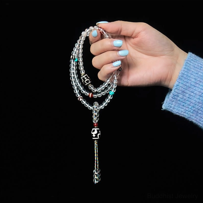 Delicate Buddhist prayer mala with twisted crystal strands and protective dzi tassel