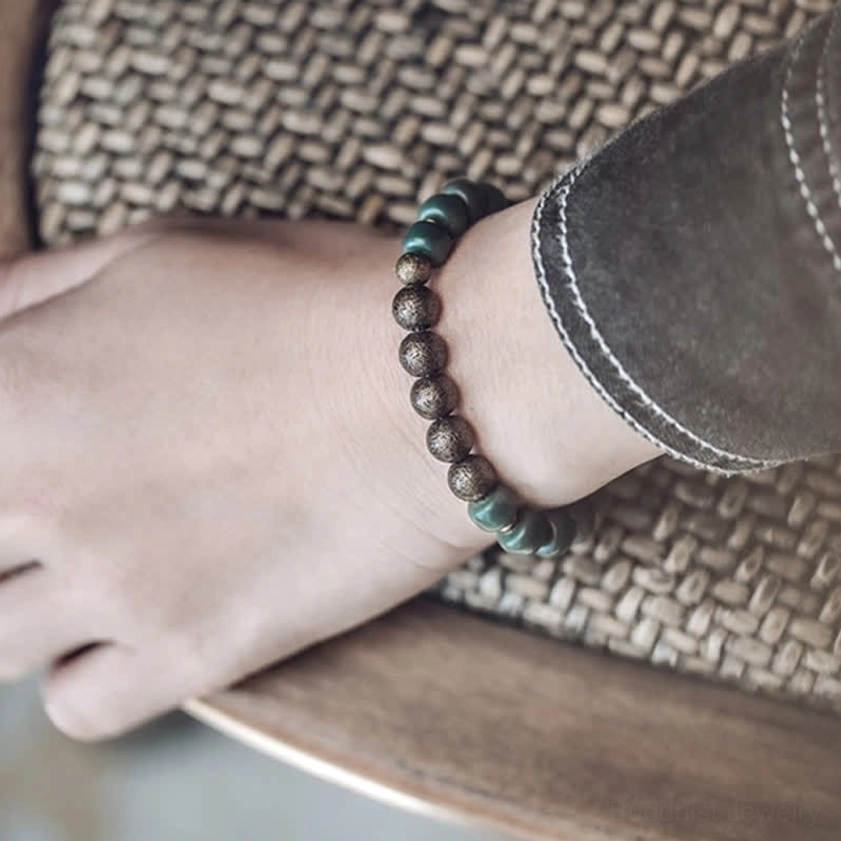 Buddhist bodhi seed bracelet side view on wrist displaying casual daily wear style on woven cushion
