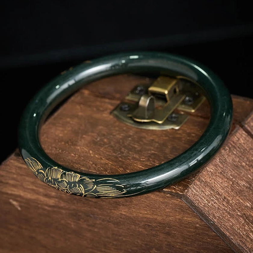 Hand-carved cyan jade bangle with lotus koi fish engraving, detailed side perspective