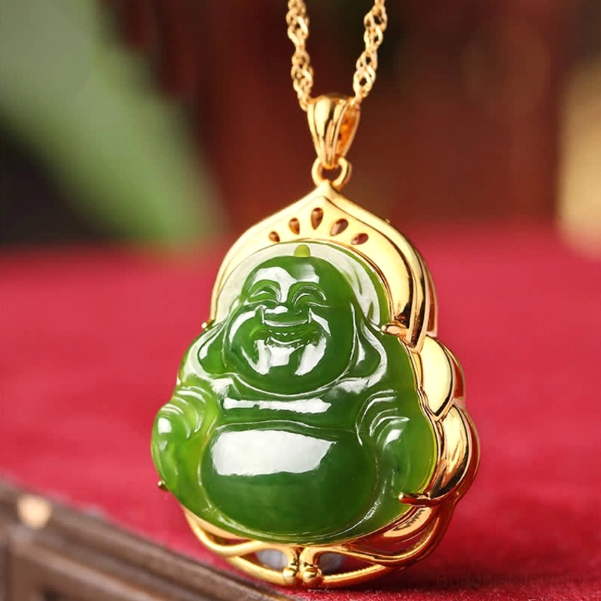 Green jade Laughing Buddha pendant necklace with gold chain on red velvet background, front centered view