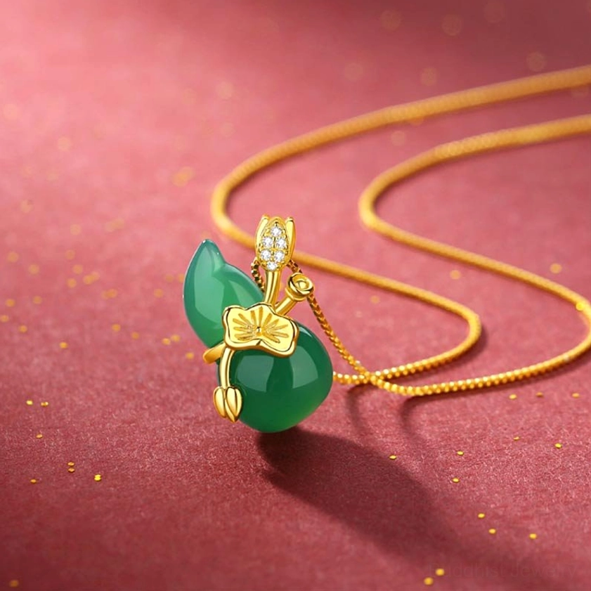 Cyan jade gourd pendant necklace with gold-plated silver chain and lotus leaf detail, showing side close-up view with sparkling background