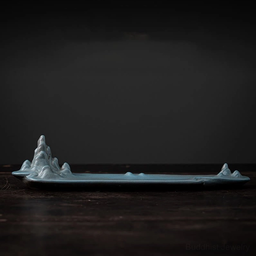 Cyan colored ceramic mountain incense burner front view showcasing unique color variant and carved mountain peak design for meditation practice