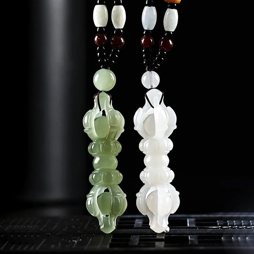 Pair of Hetian jade Dorje Vajra pendants in cyan and white with beaded lanyard, front view showcasing both Buddhist jade variants