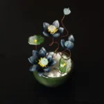 Dark blue liuli glass lotus flower pot with handcrafted ceramic base and metal stems spiritual decor overhead view