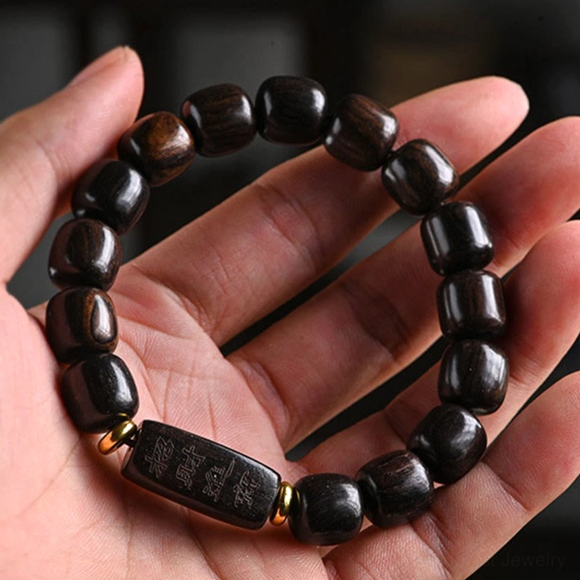 Dark natural ebony wood Buddhist bracelet featuring polished barrel beads and decorative carved accents