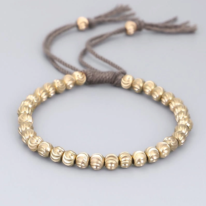 Dark gray cotton cord copper bead bracelet with adjustable sizing, front view