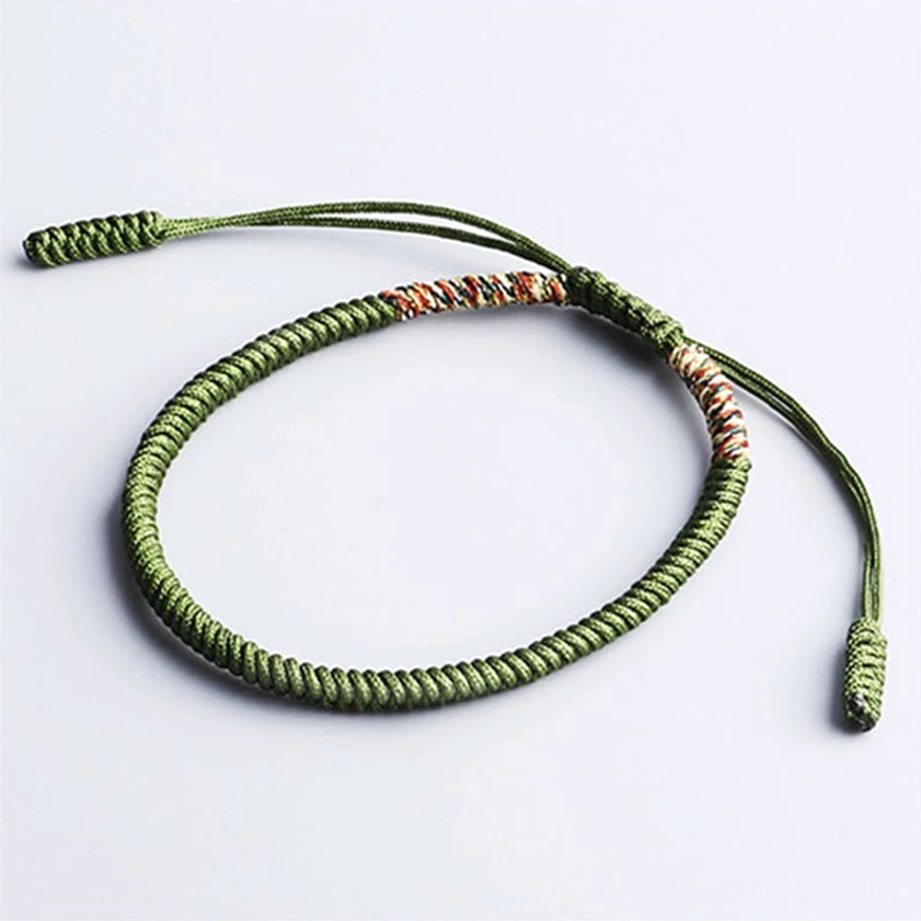 Dark green Buddhist luck bracelet with handwoven King Kong Knot design and adjustable braided cord closure