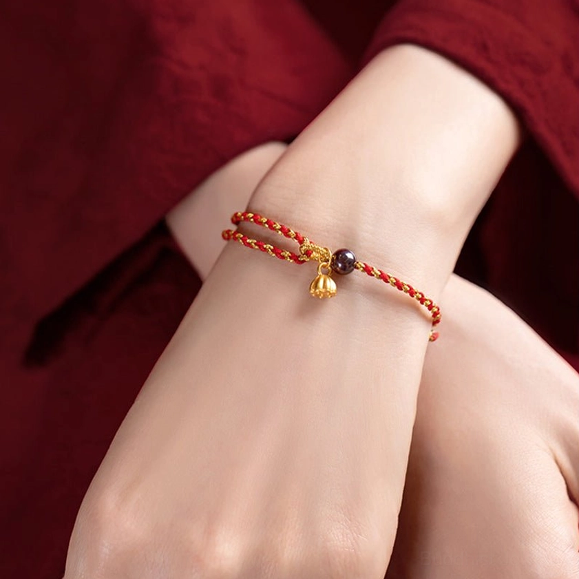 Dark red gold lotus bracelet with silver charm showing handcrafted details and texture