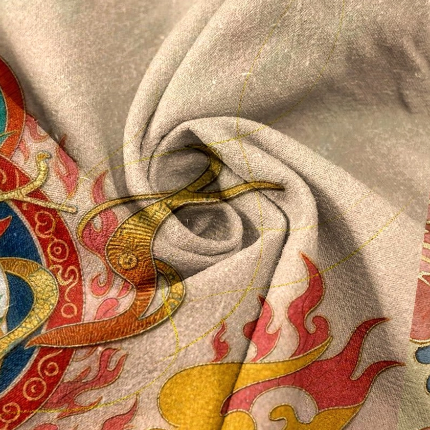 Spiritual flame and divine deer motif with golden decorative lines on soft woven cotton texture