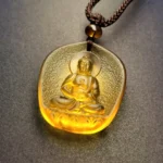 Dog and Pig Zodiac Amitabha Buddha Liuli Crystal Pendant - Warm Amber Glaze with Embossed Seated Buddha Design