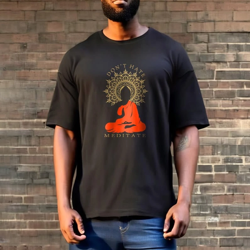Black graphic t-shirt with meditation Buddha design on male model brick wall background