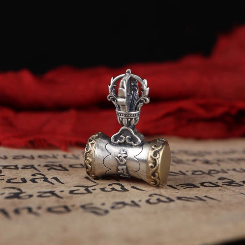 Dorje drum pendant in sterling silver showing cylindrical drum design with vajra top and Om Mani Padme Hum engraving