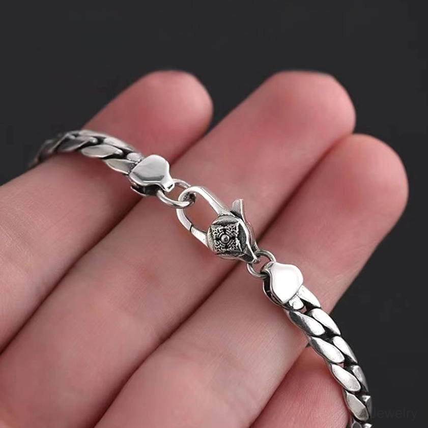 Double dorje vajra bracelet handheld showing clasp and engraved details