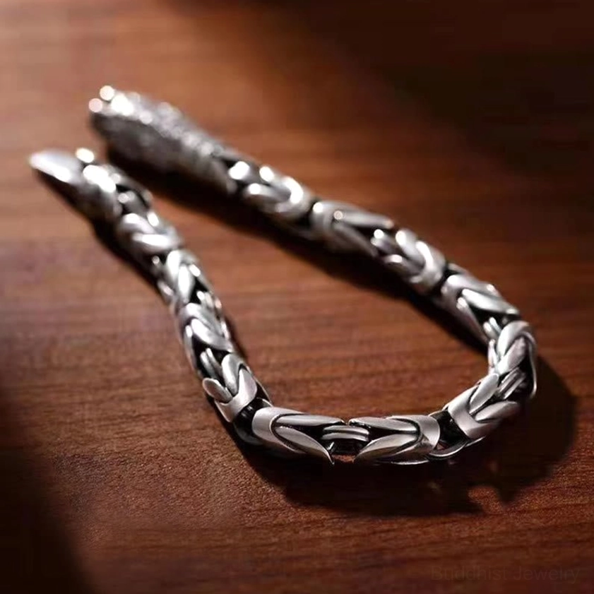 Handcrafted copper wheat link bracelet with aged silver finish, close-up overhead view showing interwoven chain design