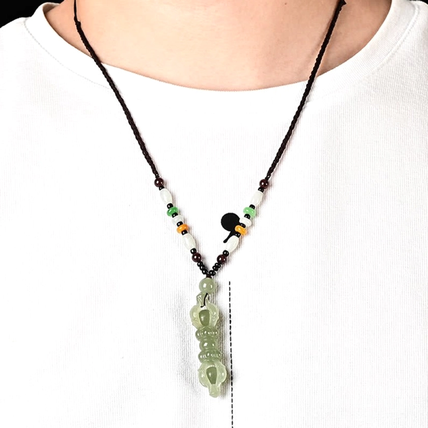 Hetian jade Dorje Vajra Buddhist necklace worn on person with white t-shirt, showing braided rope with colorful beaded decorations around neck