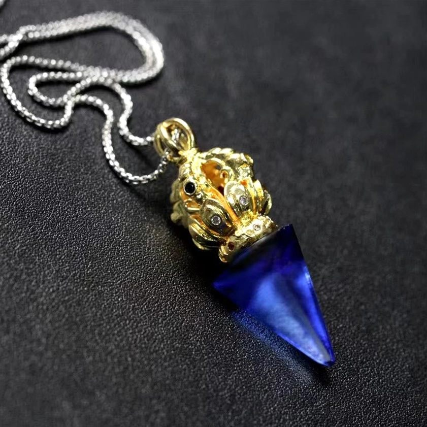 Dorje Vajra liuli crystal necklace pendant detail - overhead angle showing intricate vajra design and blue crystal