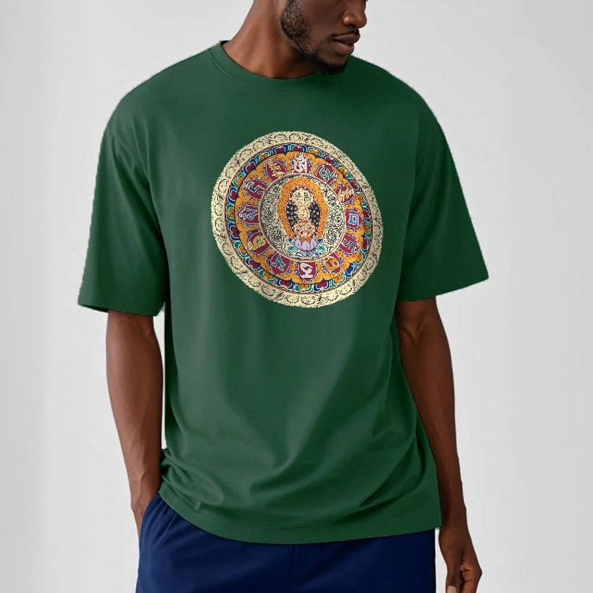 Male model wearing dark green Dorje Vajra Mandala Buddhist cotton t-shirt with detailed mandala chest print, styled with navy trousers