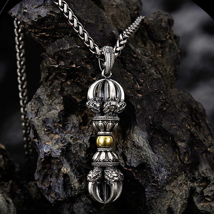 Dorje vajra copper pendant necklace front oblique view with vintage silver and gold details on dark rock backdrop