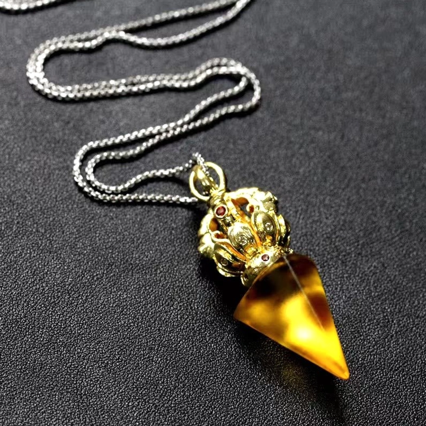 Dorje Vajra yellow crystal pendant overhead view - handmade liuli glass with gem-inlaid gold cap