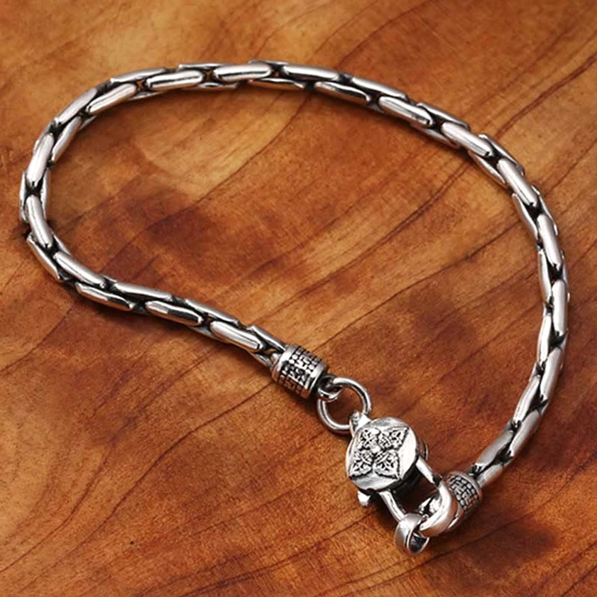 Double Dorje Buddhist bracelet angled view showing vajra engraved clasp and vintage metal texture