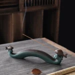 Double Koi Fish ceramic incense burner with smoking incense stick on tea table