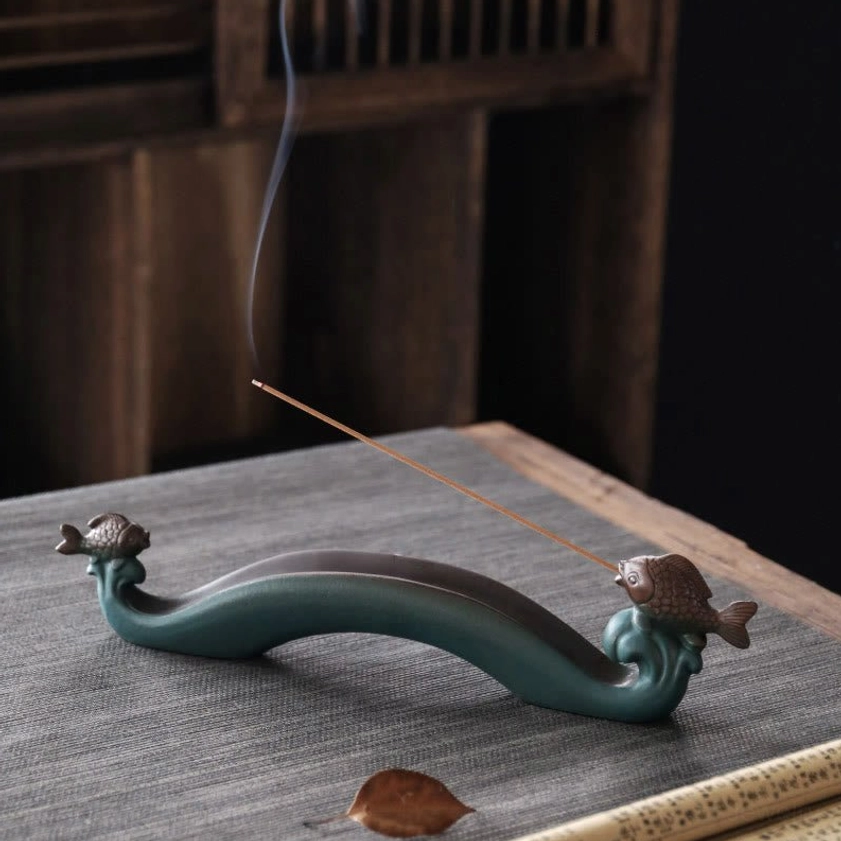 Double Koi Fish ceramic incense burner with smoking incense stick on tea table