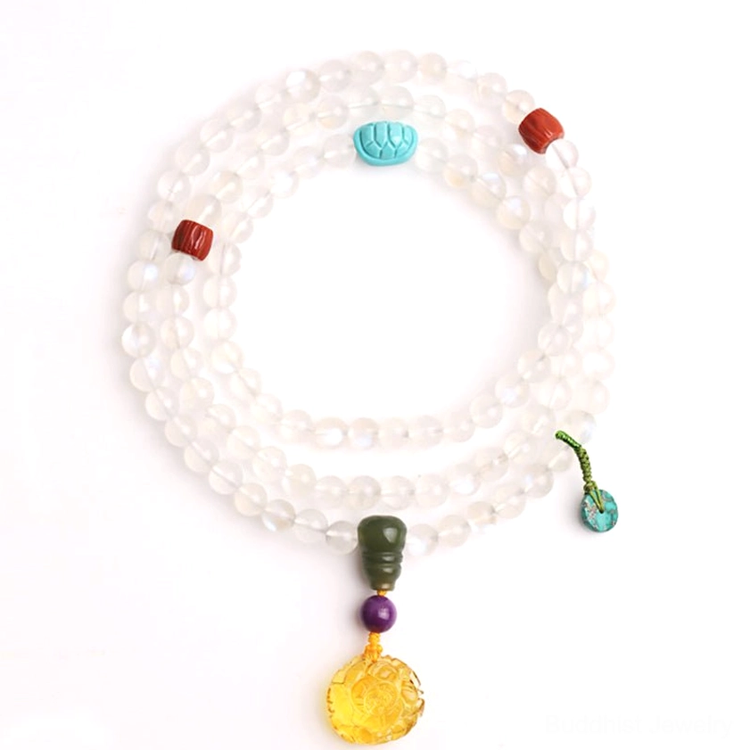 Double-loop moonstone mala bracelet on light background, translucent beads with red agate and turquoise accents