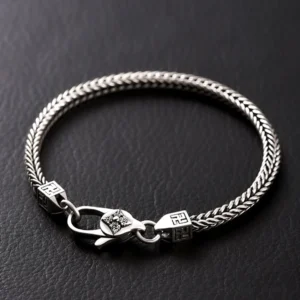 Double Vajra Buddhist bracelet with swastika symbol and lobster clasp, handmade copper chain displayed on dark leather background