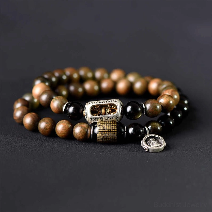 Close-up top-down view of double wrap bracelet showing split sandalwood and obsidian bead design with Buddha pendant