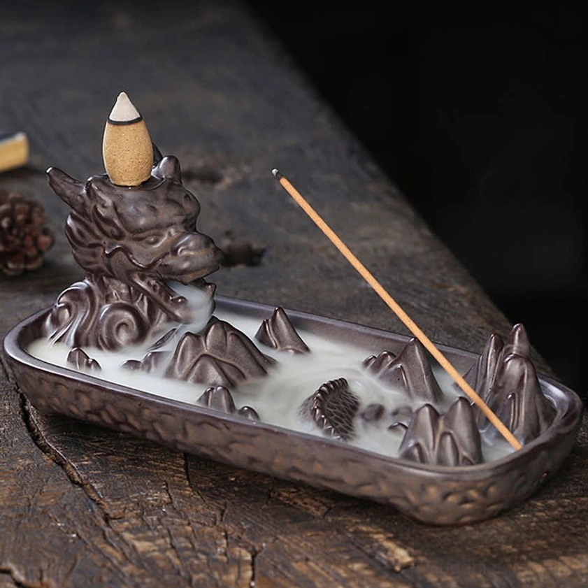 Dragon backflow ceramic incense burner in dark brown with mountain landscape tray, left front view showing intricate dragon head and incense cone