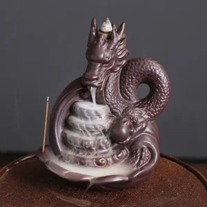 Dragon ceramic backflow incense burner with detailed scaled dragon design, dark brown matte finish, featuring flowing incense smoke in front three-quarter view on wooden surface