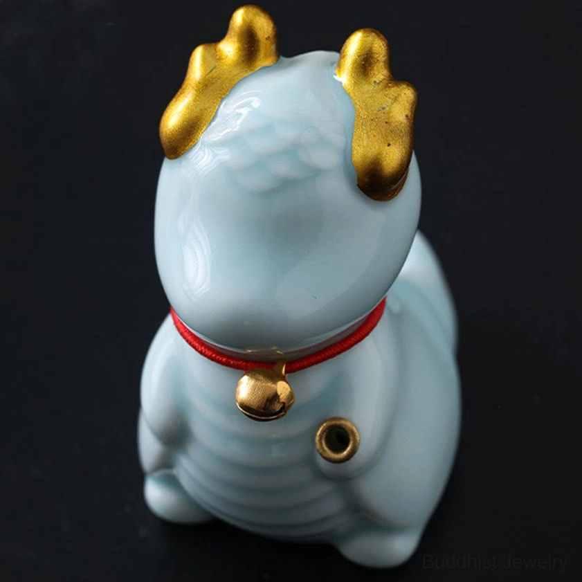 Dragon bell incense burner front side close-up showing ridged ceramic torso and golden bell collar details