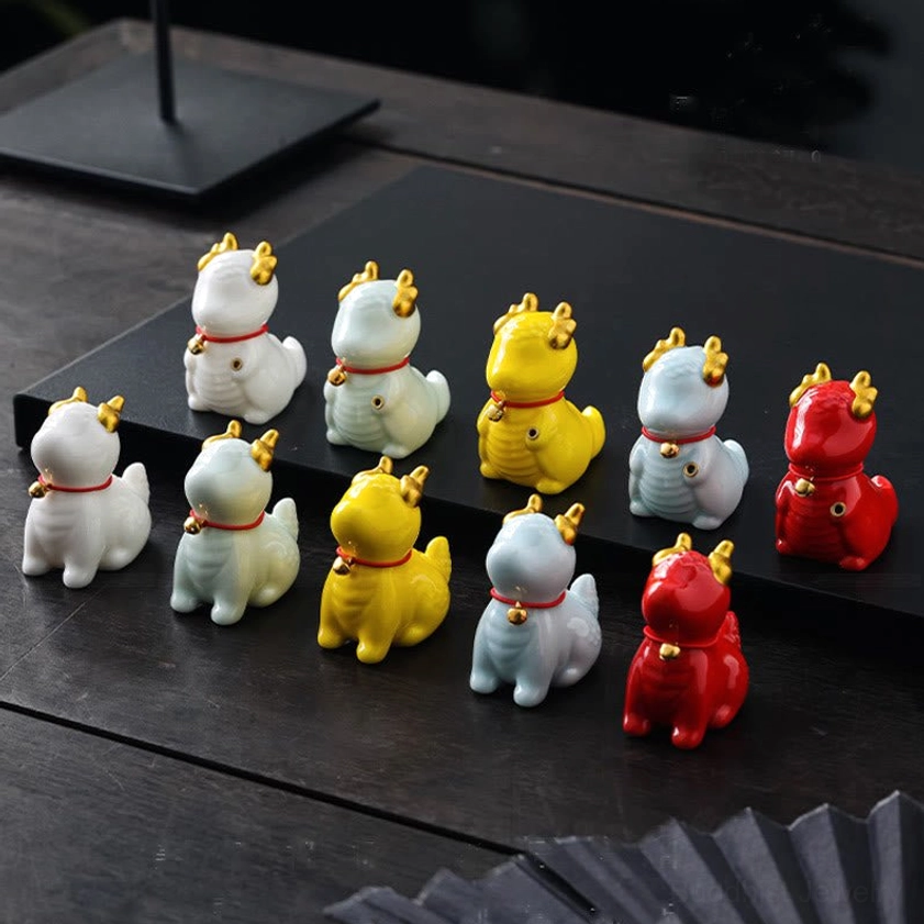 Assorted dragon bell incense burners in multiple colors - blue, white, yellow, red - top-down display view