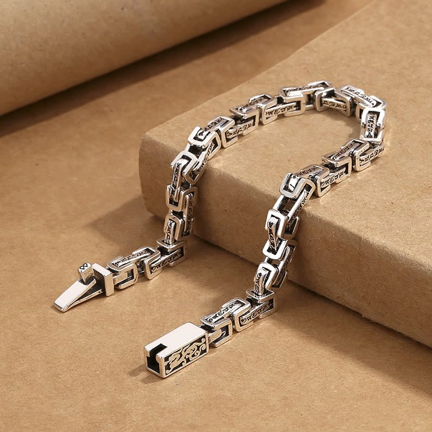 Vintage style Buddhist dragon bracelet three-quarter angle showing antique copper finish and buckle clasp